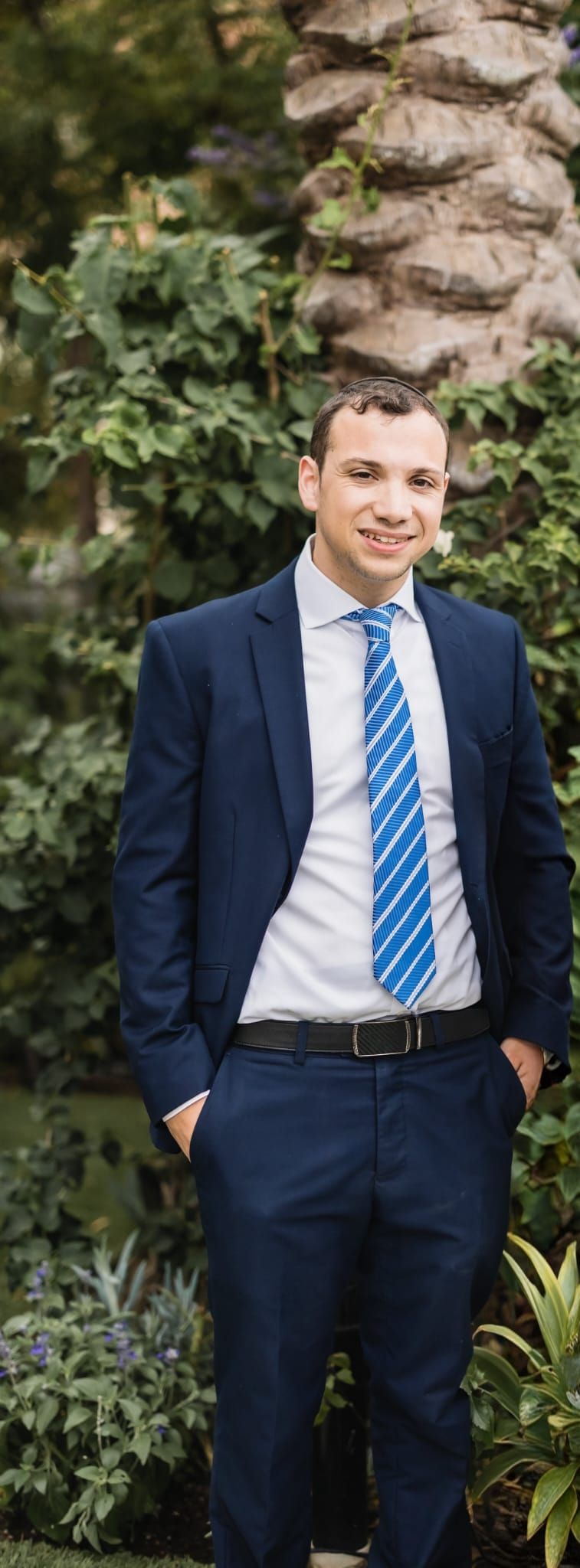 Rocky Friedman, founder of Rocky Ridge Counseling, smiling outdoors in a navy suit